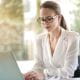 Female in smart attire working on her laptop